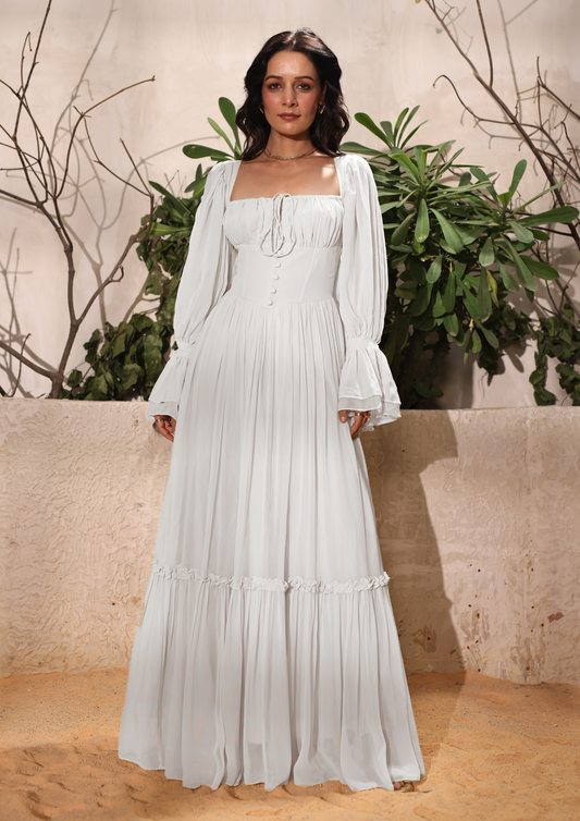 Seoraa white maxi dress with a corset bodice, delicate button accents, ruched sleeves, and a flowing tiered skirt—perfect for birthdays, date nights, and summer wear