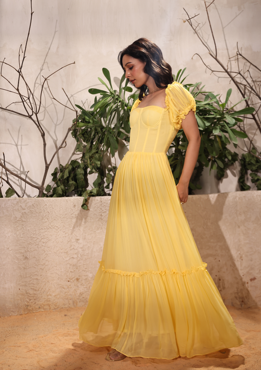 Seoraa yellow long maxi dress with puff sleeves, bustier bodice, crisscross back, and frills—perfect for vacations, birthday celebrations, and Haldi functions